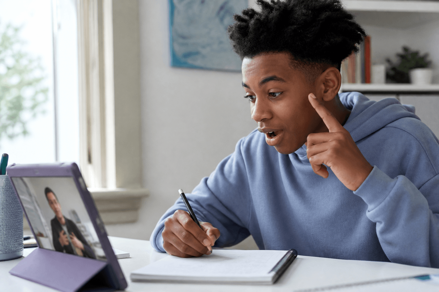 A learner and tutor share a breakthrough while studying together